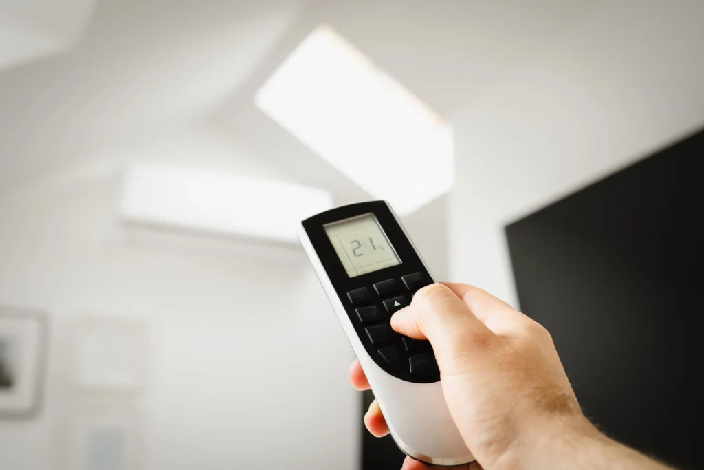 Picture of a hand holding an AC remote control