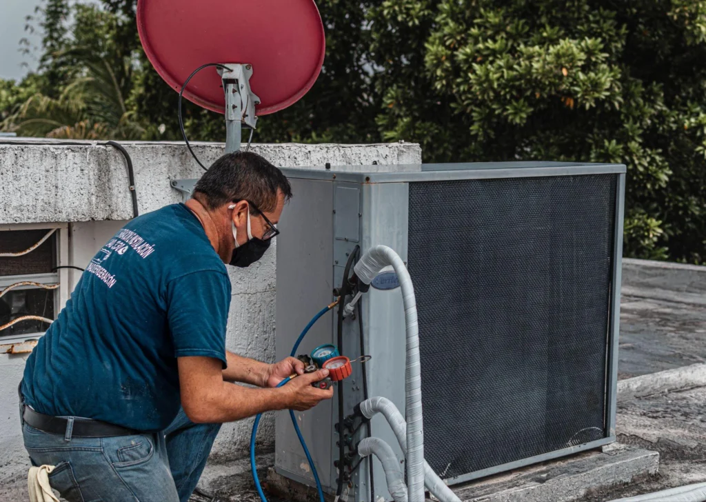 Picture of a technician checking a rooftop AC unit