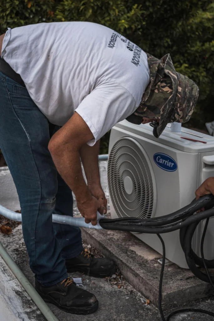 Picture of a technician installing an outdoor HVAC unit