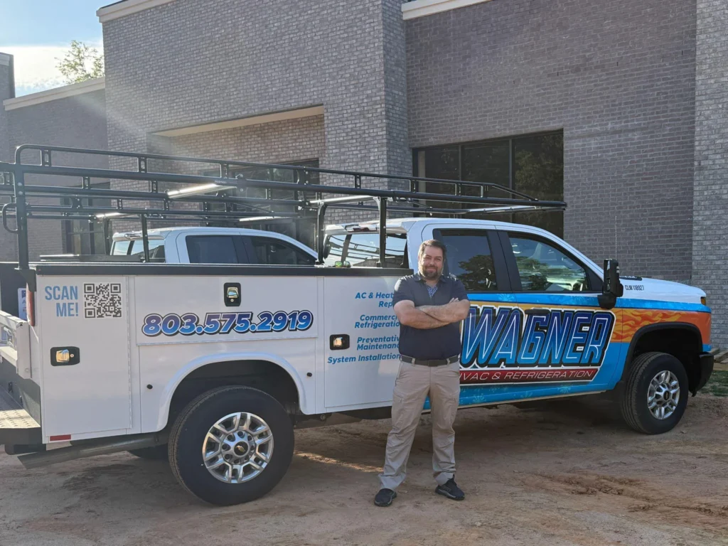Picture of a man standing in front of a Wagner HVAC service truck