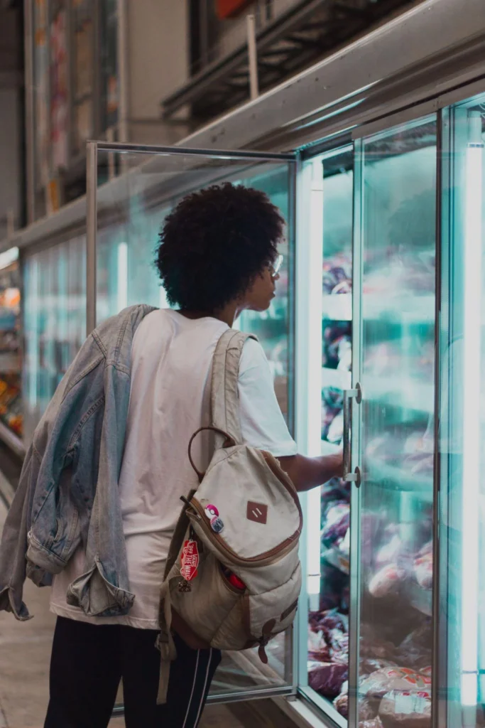Picture of a person looking inside a refrigerator