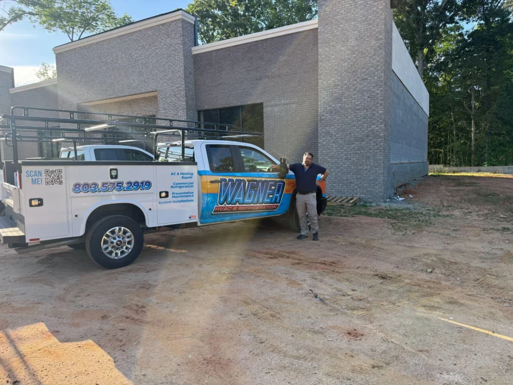 picture of a technician leaning against a work truck
