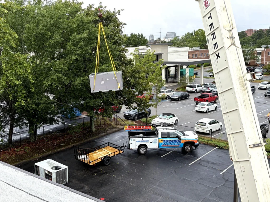 picture of a crane lifting an hvac unit