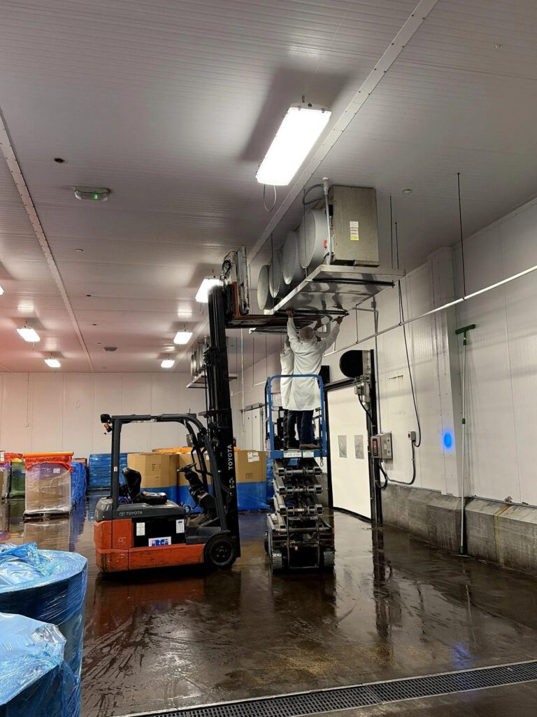 Picture of technicians servicing an industrial refrigeration unit