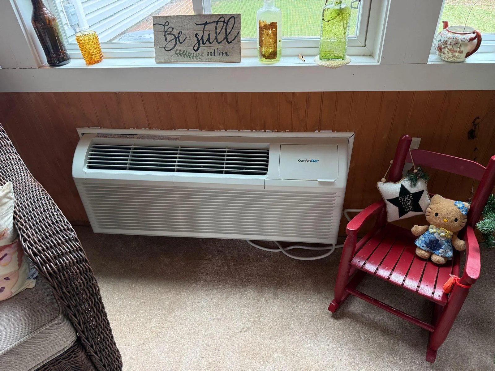 Picture of a PTAC air conditioning unit under a window