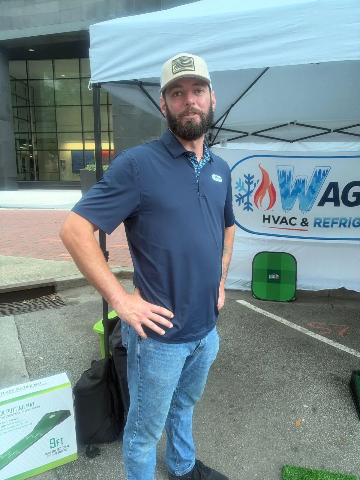 Picture of a technician standing by a Wagner HVAC booth