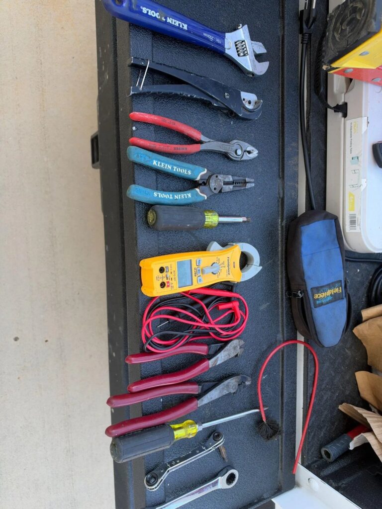 Picture of must have HVAC service tools laid out on a truck tailgate