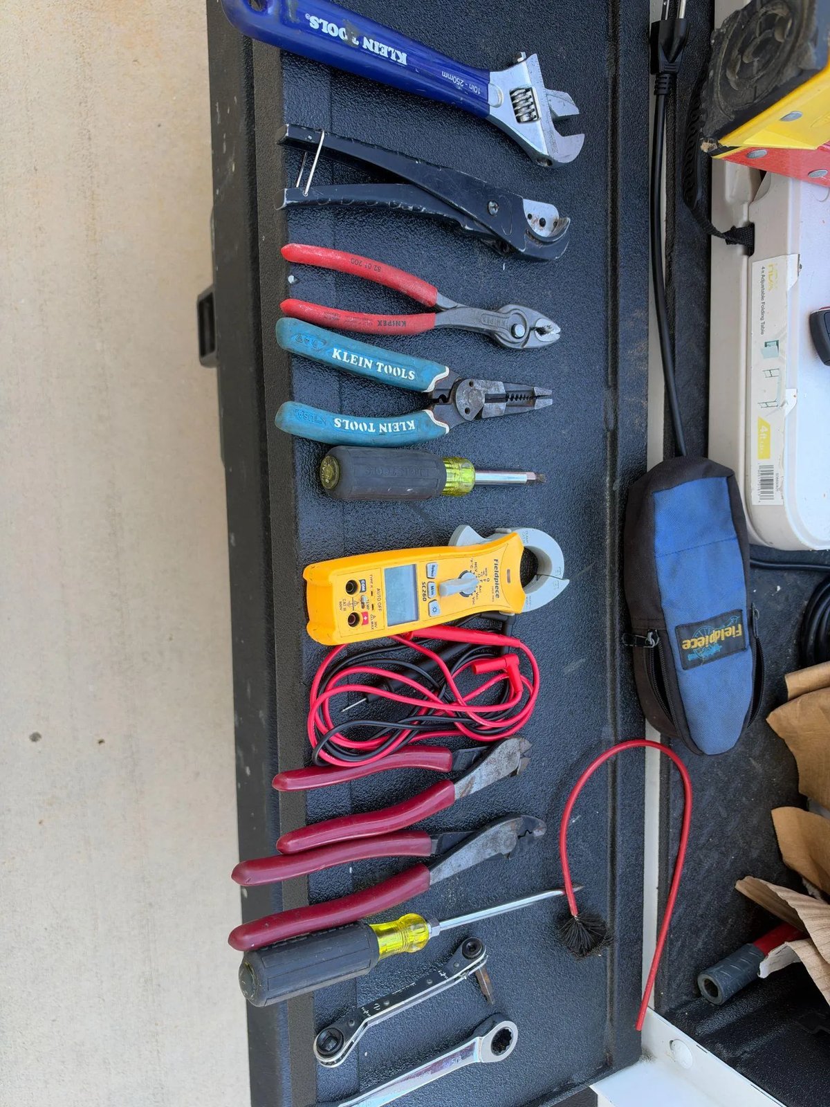 Picture of must have HVAC service tools laid out on a truck tailgate