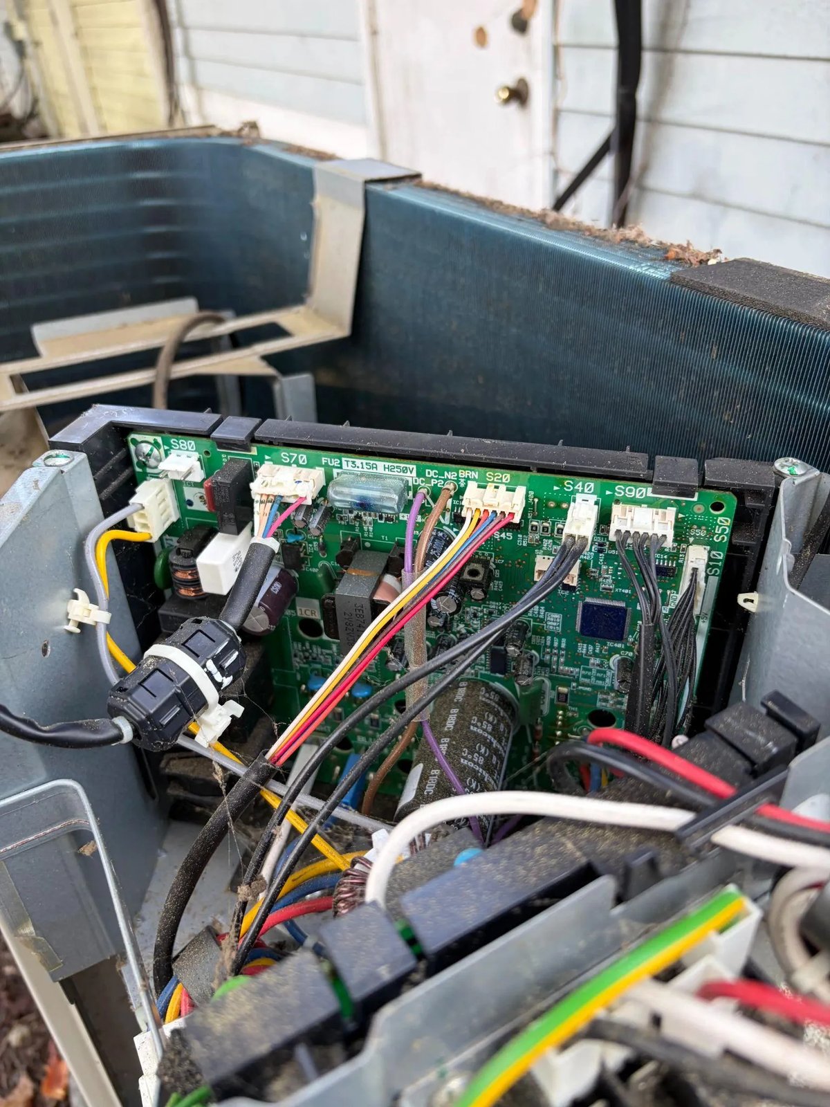 Picture of an open HVAC electrical control board with wiring
