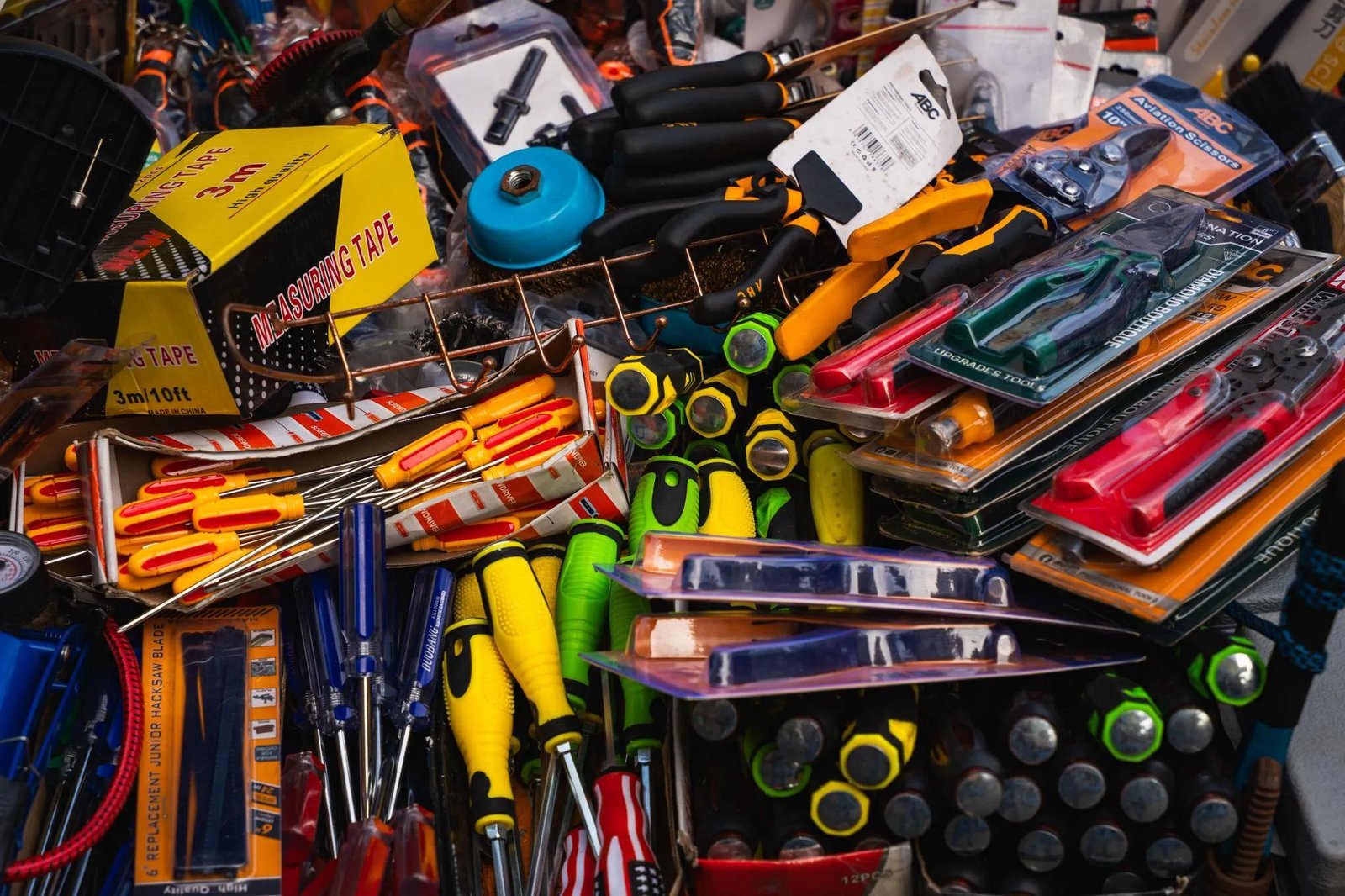 Picture of a pile of packaged hand tools and measuring tapes